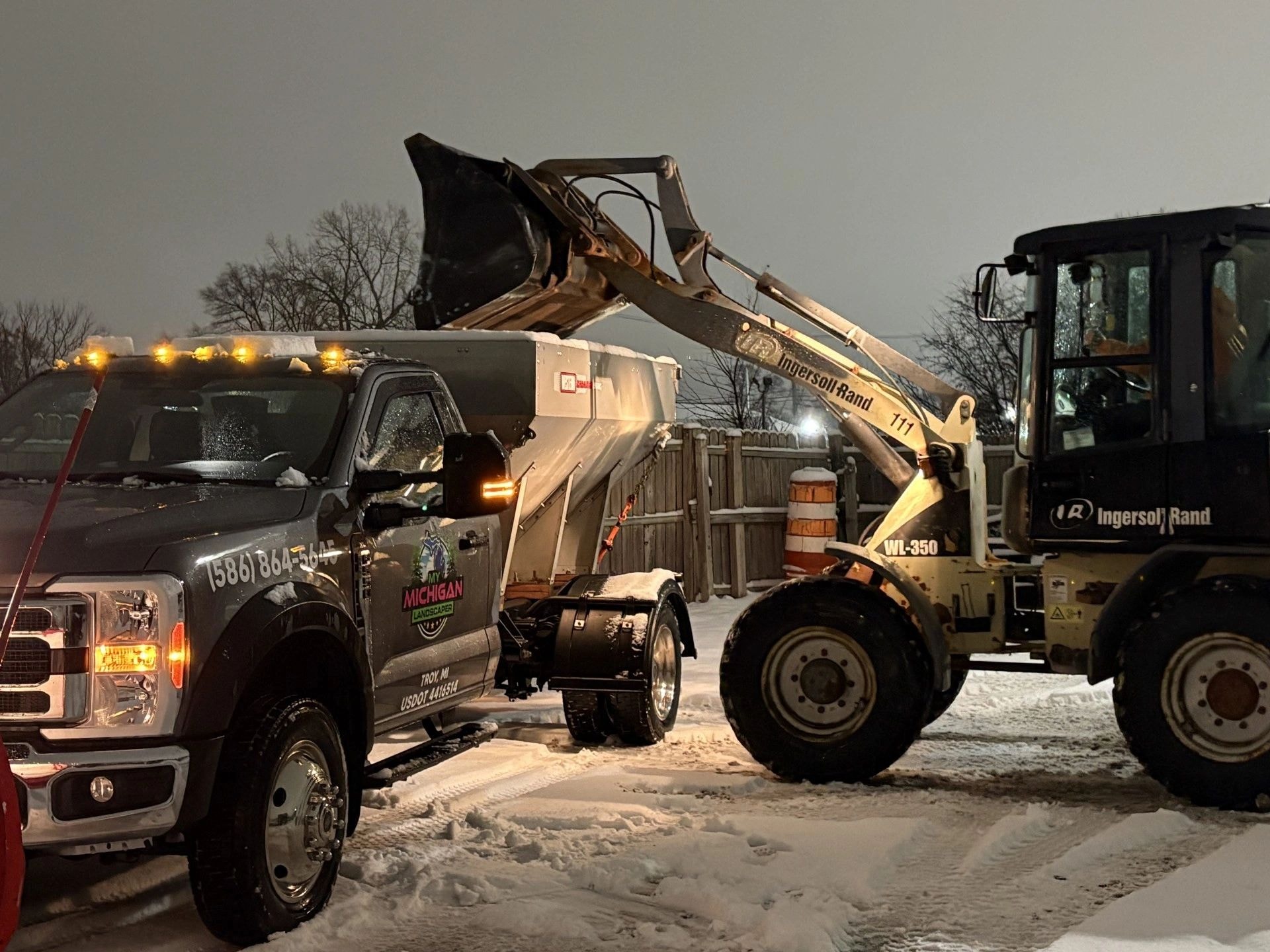 Loader moving snow from a commercial parking lot